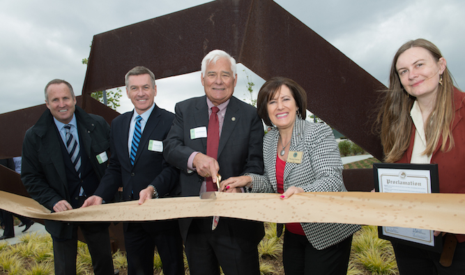Civic and business leaders join the artist's daughter to cut the ribbon on "San Mateo Bridge"
